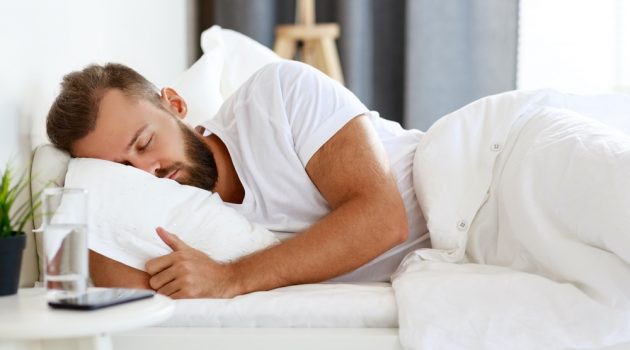 Duvet vs. Comforter: What's the Difference? Man Sleeping Duvet