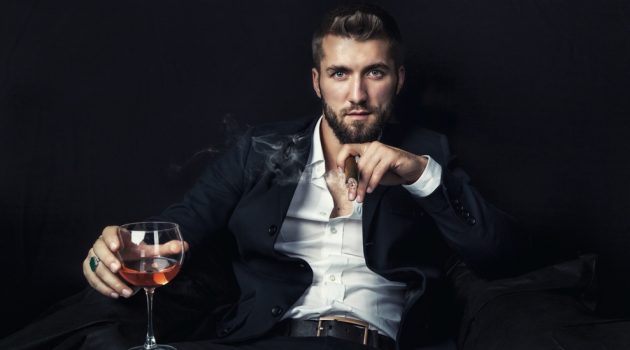 Cigars: More Than a Habit Man Smoking Cigar with Glass of Wine