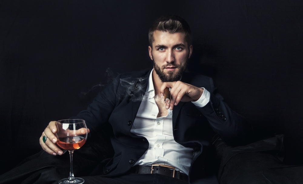 Man Smoking Cigar with Glass of Wine