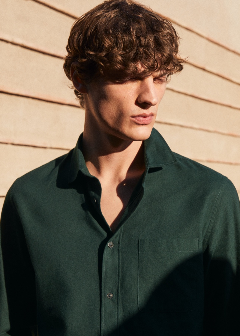 Valentin Caron sports a smart button-down shirt in forrest green from Mango.