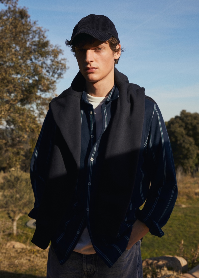Layering for a brisk day, Valentin Caron embraces preppy style from Mango.