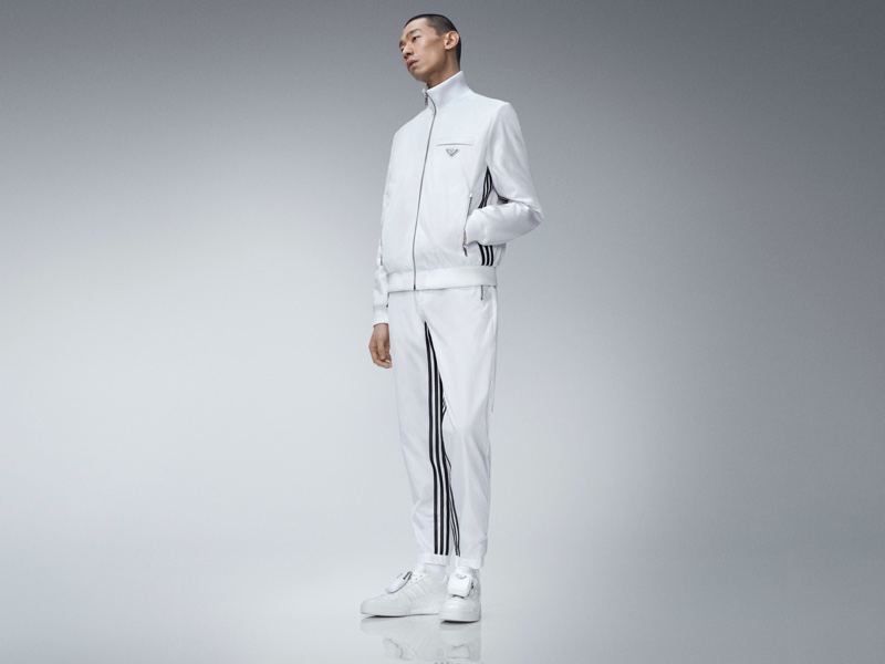 Zhuo Chen sports a white tracksuit from the Prada x adidas collection.