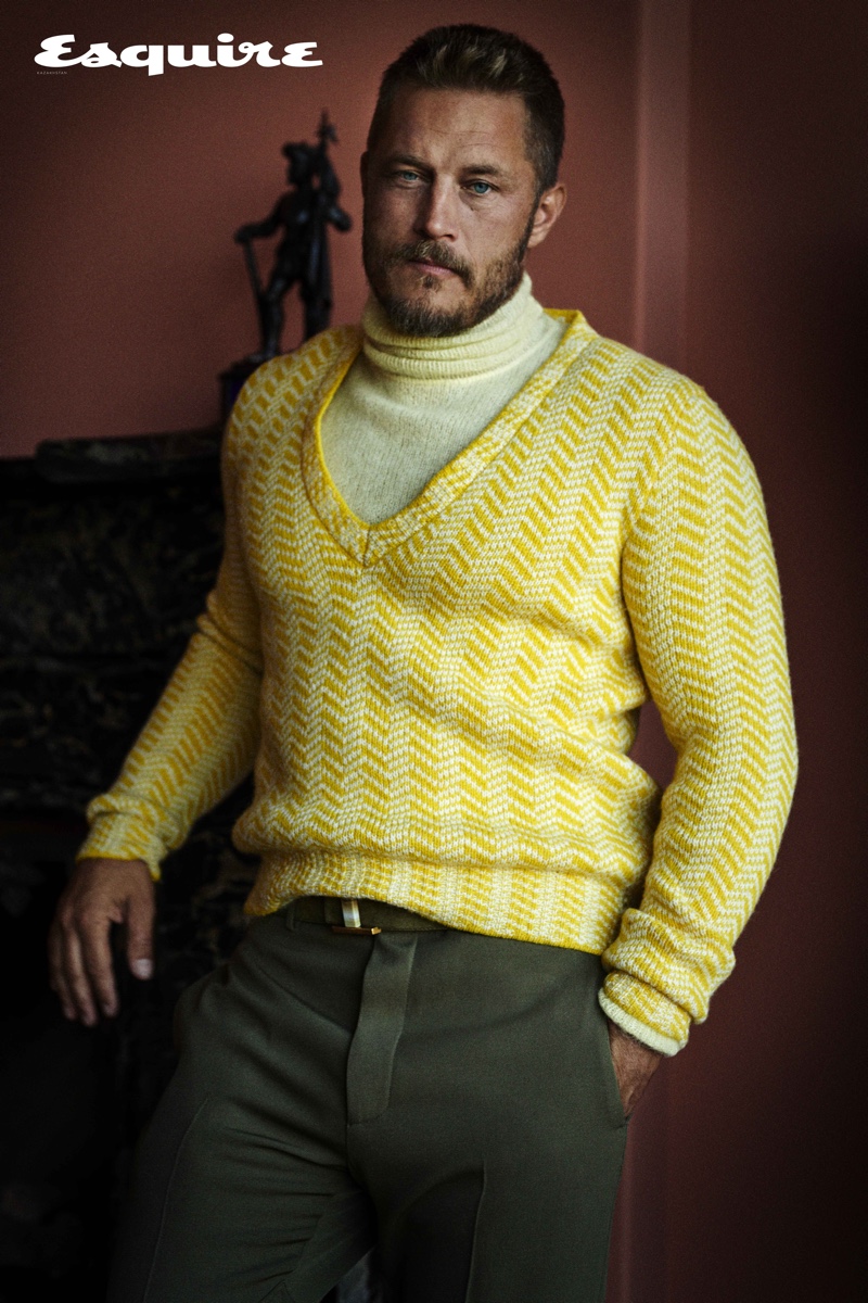 Embracing yellow, Travis Fimmel dons a turtleneck and sweater from Prada with a Tod's belt and pants for Esquire Kazakhstan.