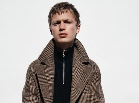 In front and center, Jonas Glöer models a double-breasted plaid coat from Zara.