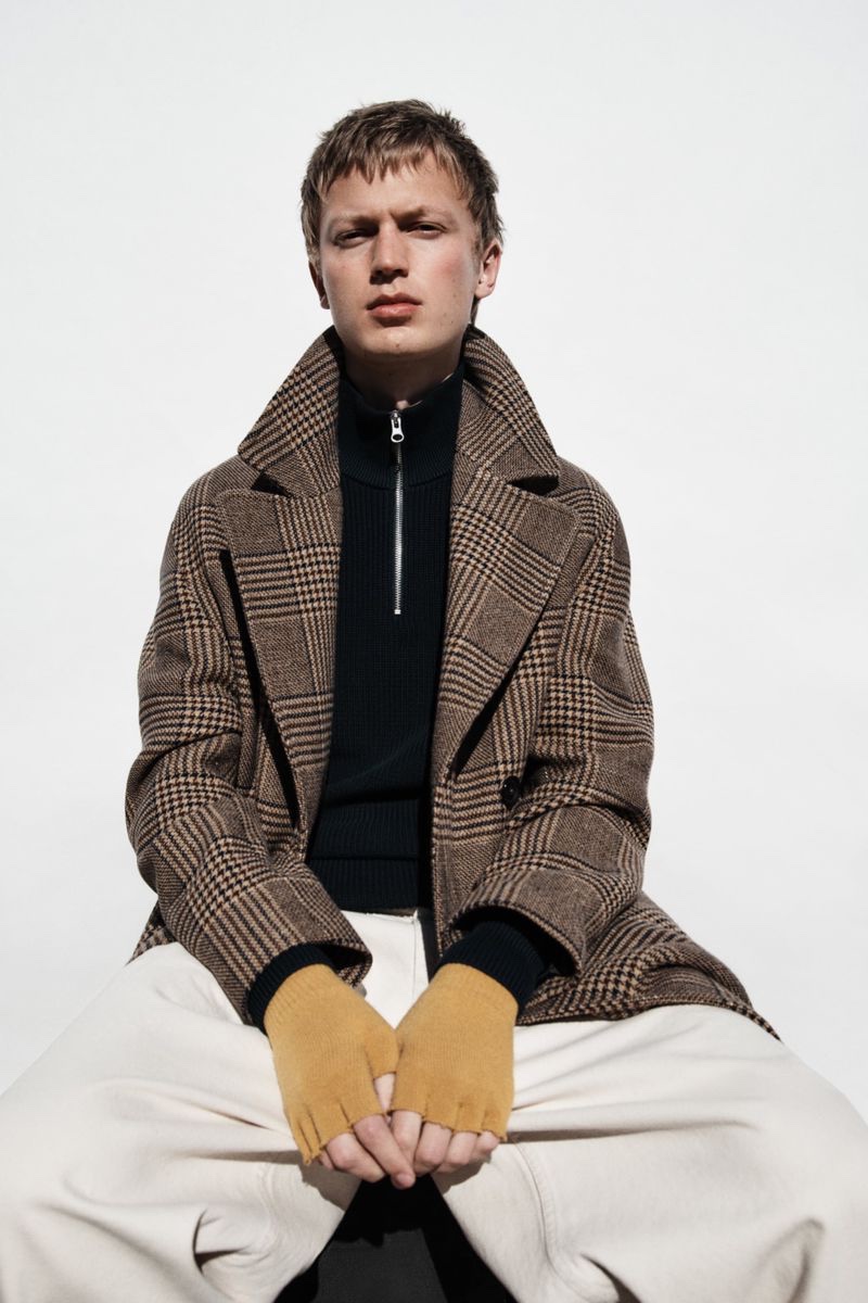 In front and center, Jonas Glöer models a double-breasted plaid coat from Zara.