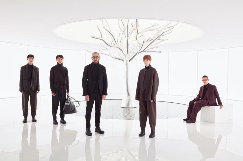 Zegna artistic director Alessandro Sartori poses with models for the brand's fall-winter 2022 collection.