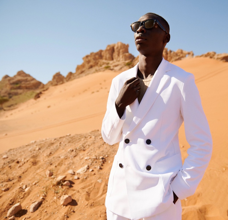 Khaby Lame dons a sleek double-breasted BOSS suit in white.