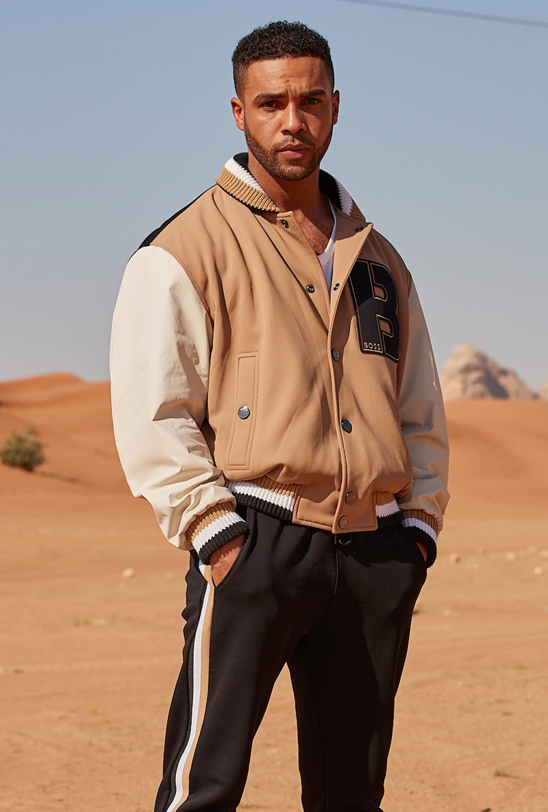 Lucien Laviscount dons a BOSS varsity jacket with joggers.