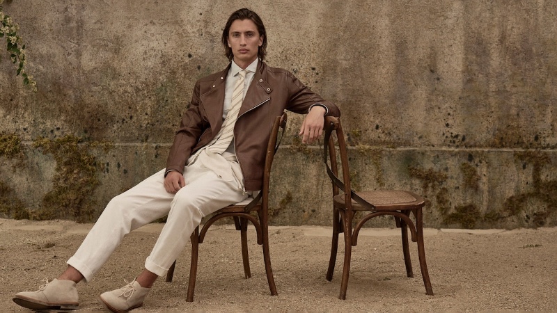 Model James Turlington sports a brown leather jacket over a shirt and tie from Brunello Cucinelli.