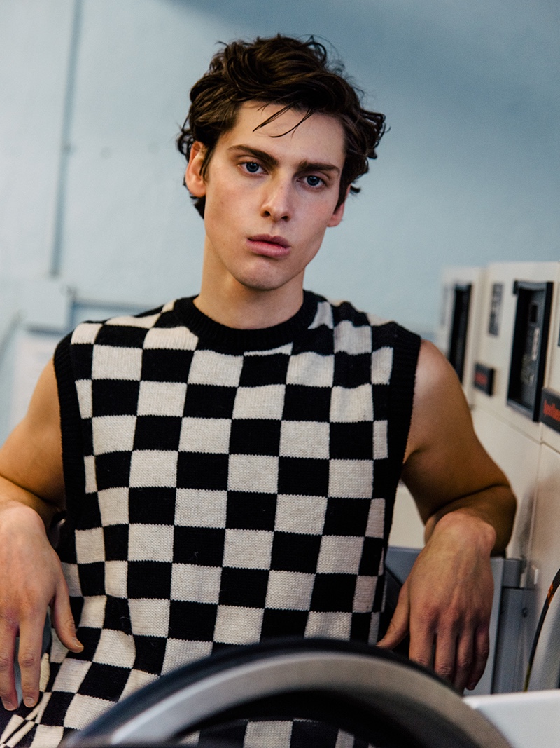 Cooper wears checkerboard print knit vest Zara.