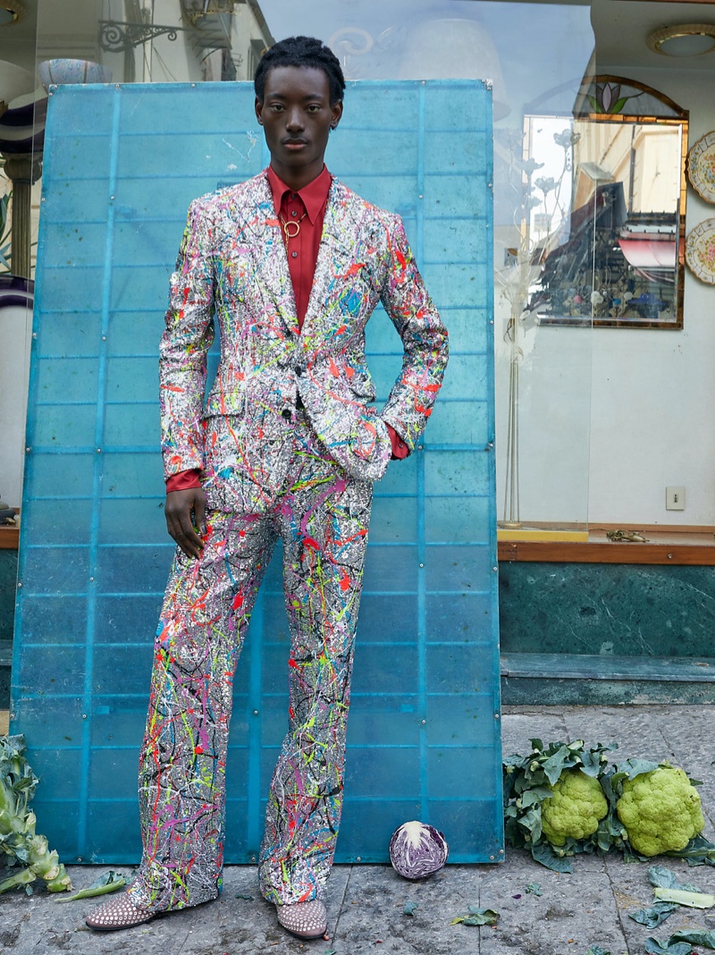 Dolce & Gabbana makes a pain-splattered statement with a suit worn by Youssouf Bamba for its spring-summer 2022 men's campaign.