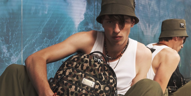 Model Clement Deheunynck poses with accessories from Dolce & Gabbana's spring-summer 2022 men's Reborn to Live collection.