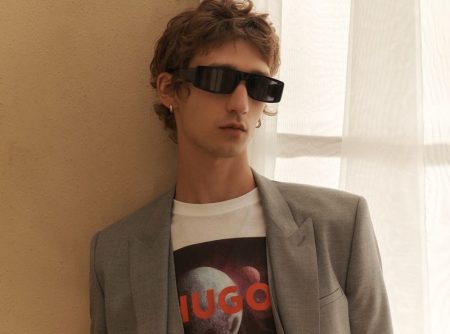 Etienne de Testa dons a modern gray suit with a HUGO logo graphic tee.
