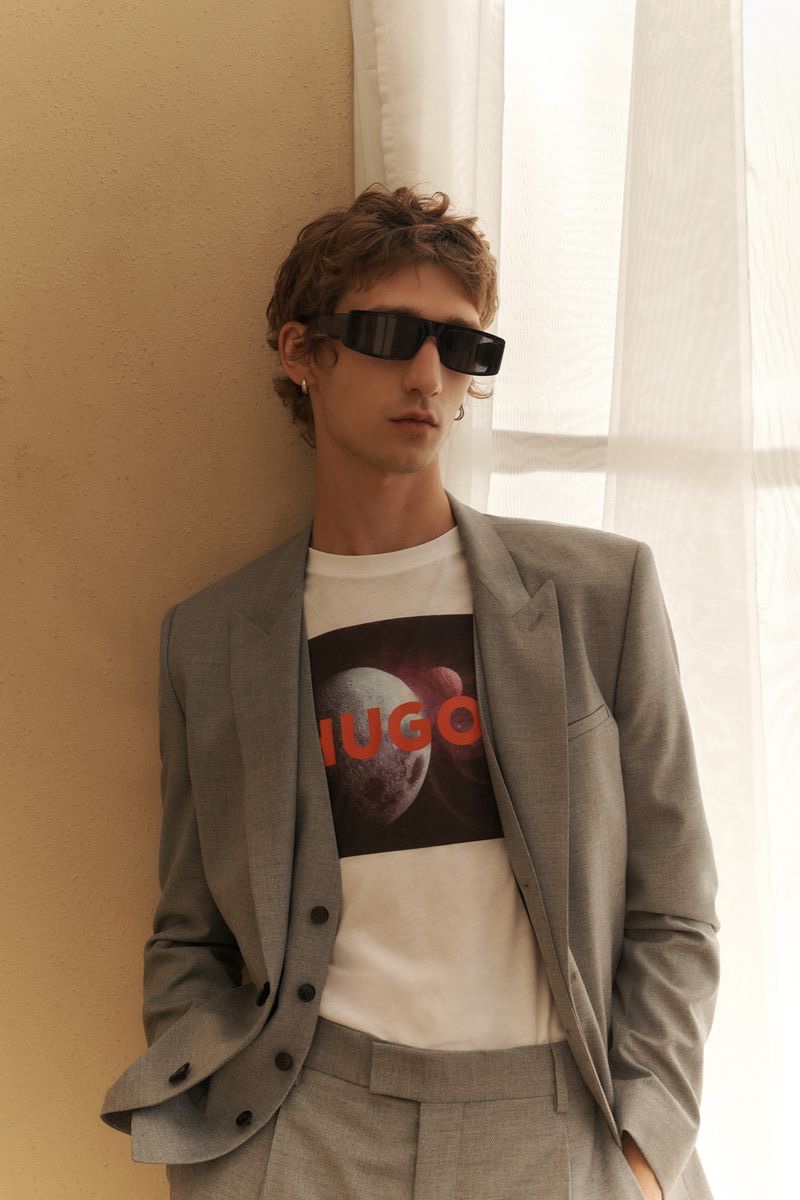 Etienne de Testa dons a modern gray suit with a HUGO logo graphic tee.