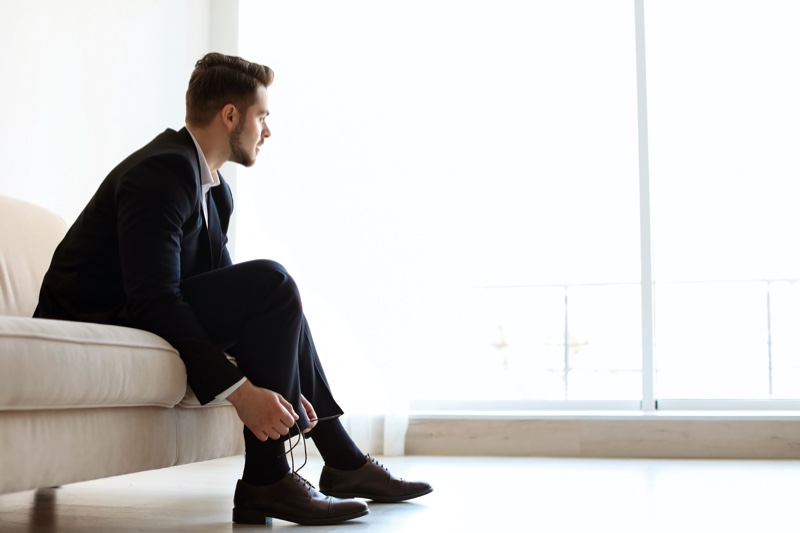 Male Model Tying Dress Shoes Sitting