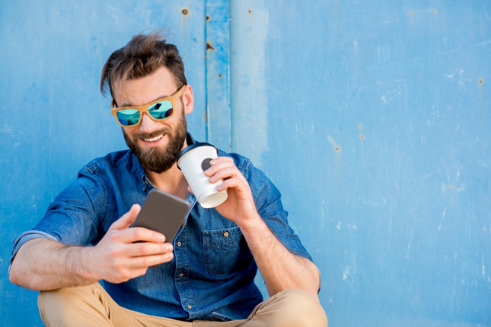 Man Wearing Sunglasses with Phone