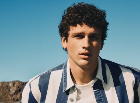 Simon Nessman wears a striped denim shirt for Mango Man's spring-summer 2022 denim campaign.