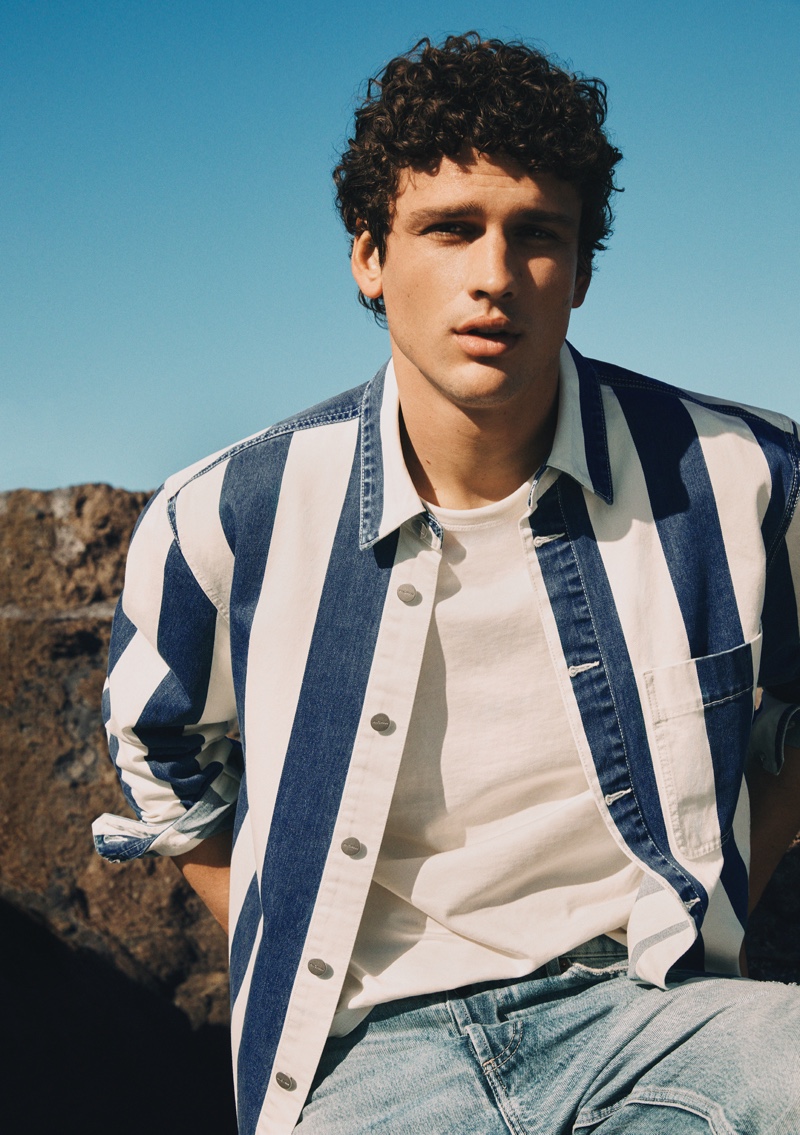 Simon Nessman wears a striped denim shirt for Mango Man's spring-summer 2022 denim campaign.