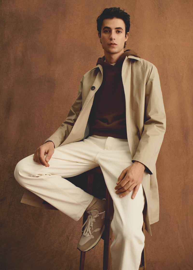 Model Oscar Kindelan wears a light coat over a hoodie from Mango Man.