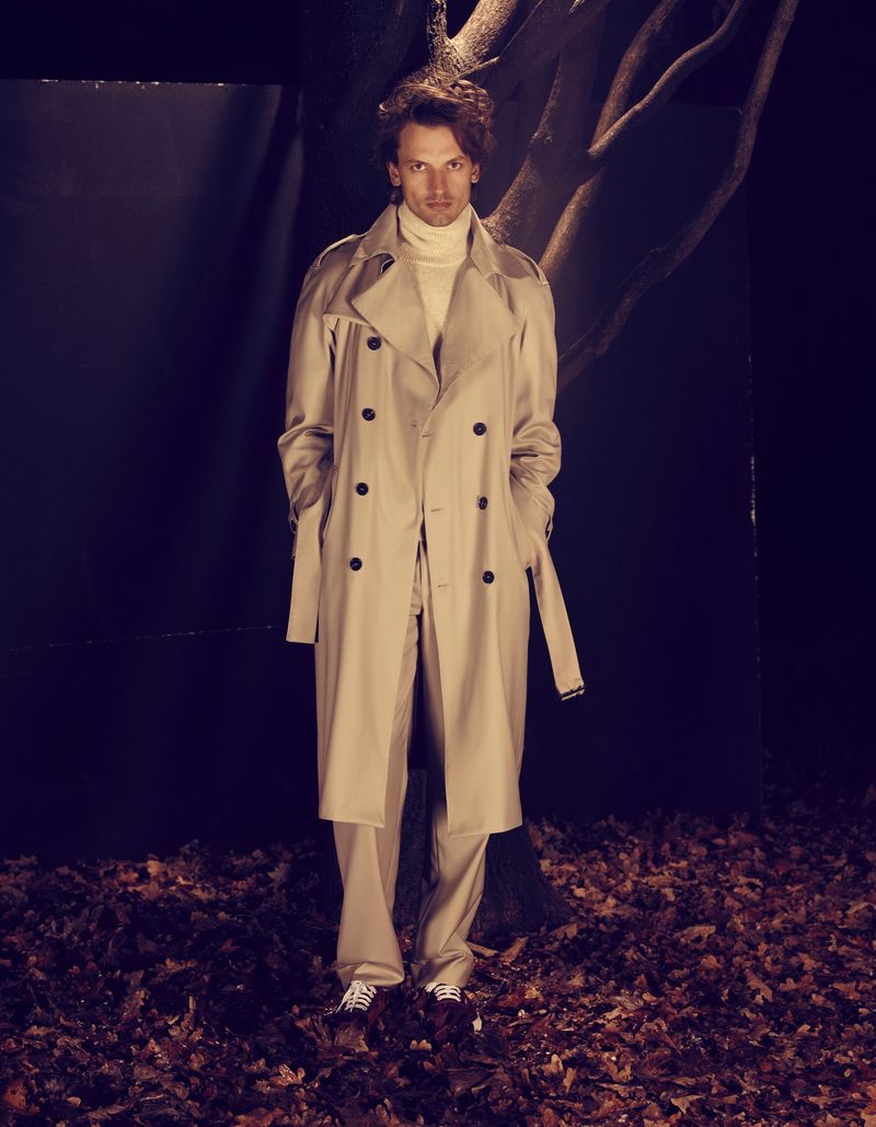 Donning a trench coat and turtleneck sweater, Eddie Klint showcases styles from Roberto Collina's fall-winter 2022 collection.