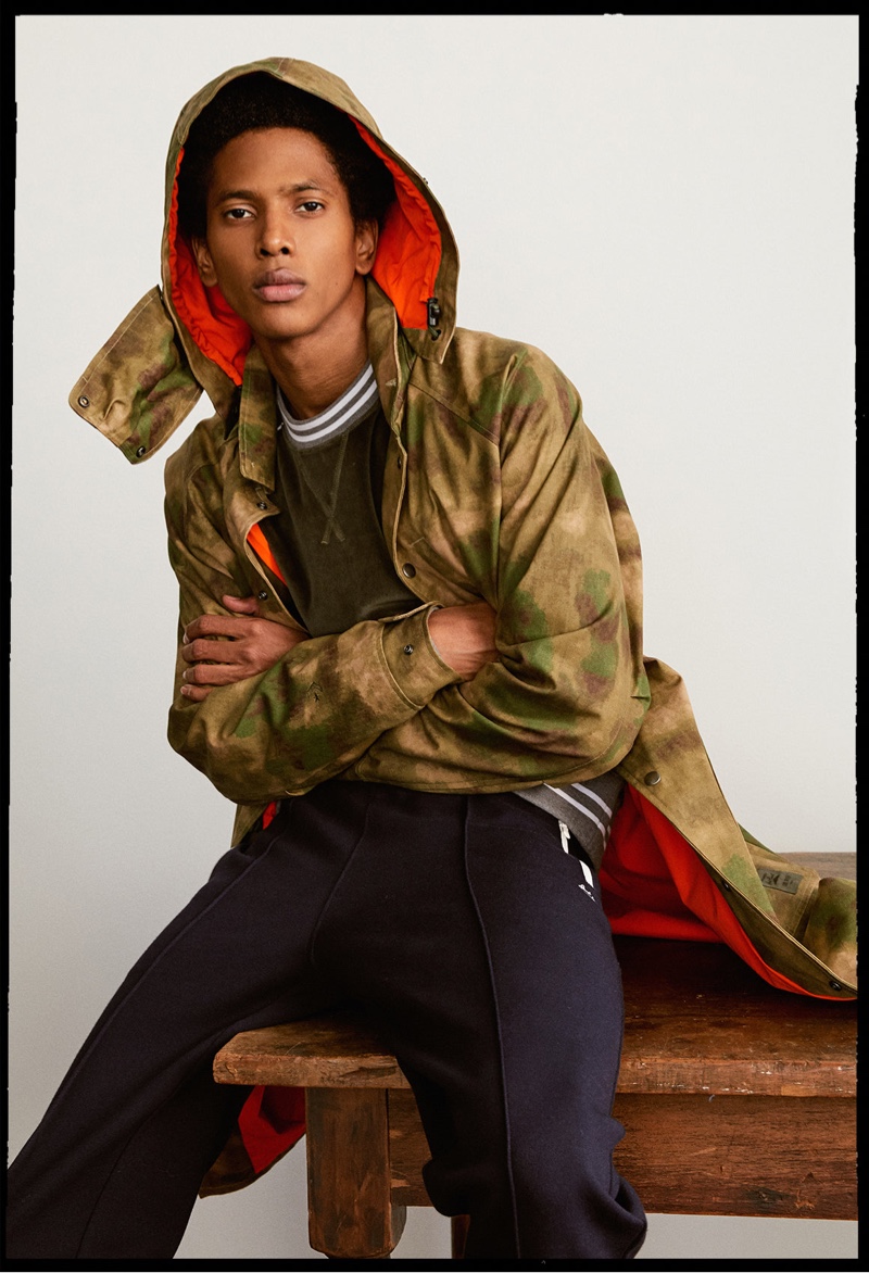 Rafael Mieses wears a Todd Snyder x Converse Jack Purcell camouflage parka with joggers and a velour crewneck.