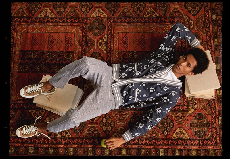 Making a graphic statement, Rafael Mieses wears a Todd Snyder x Converse Jack Purcell tennis racquet cardigan.