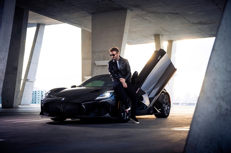 A cool vision in a black leather jacket and sunglasses, David Beckham appears beside the Maserati MC20 Fuoriserie Edition for David Beckham.