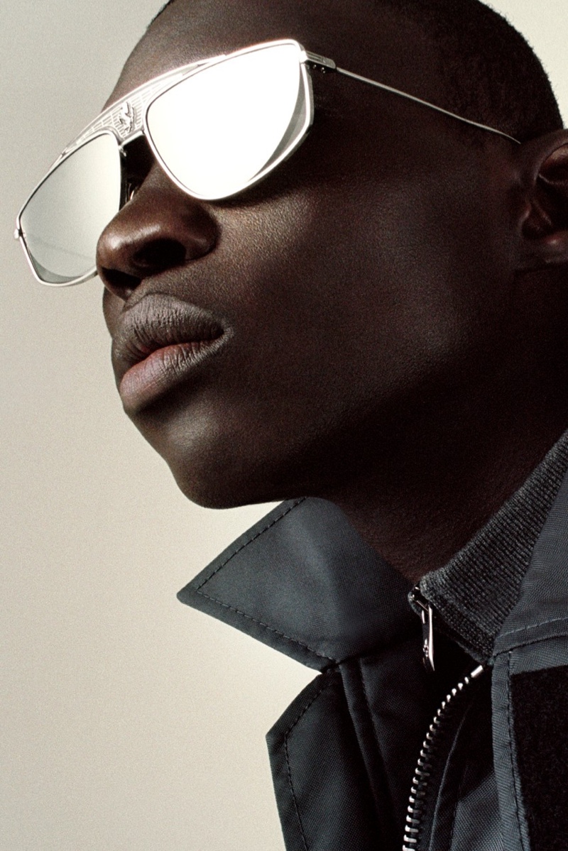 A cool vision, Fernando Cabral rocks modern sunglasses for Ferrari's spring-summer 2022 men's campaign.