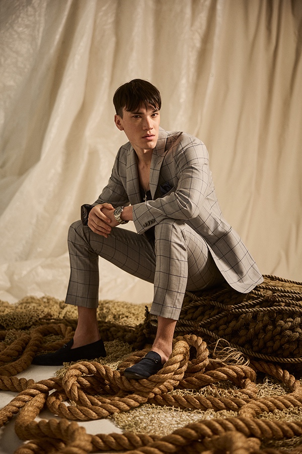 Stephen Allen wears a gray windowpane print suit from Indochino's spring-summer 2022 collection.