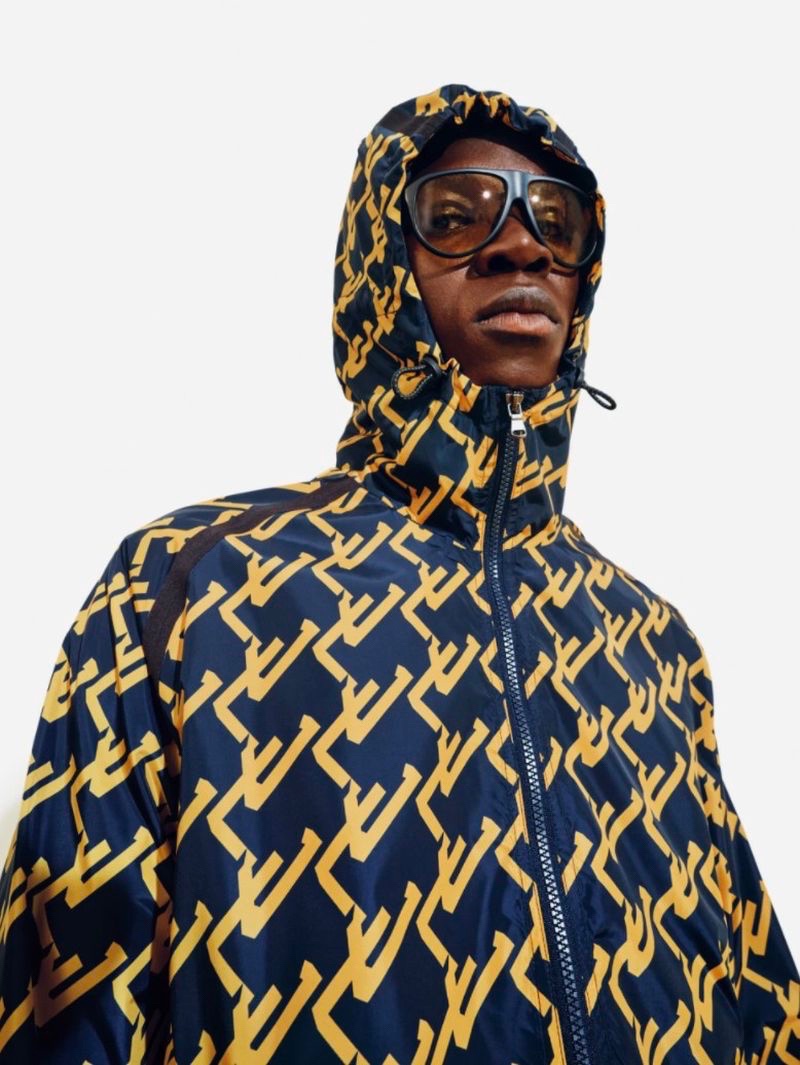 Brian Kamara makes a graphic statement in a "JL" print hooded jacket for J.Lindeberg's spring-summer 2022 campaign.