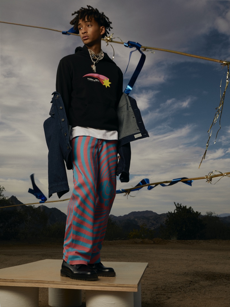 Layering in a casual look for Mr Porter, Jaden Smith wears a MSFTSrep hoodie with a t-shirt and logo trousers. He also sports Mr P. leather derby shoes, a Mateo gold pearl necklace, and Polite Worldwide 14-karat gold pearl necklace.