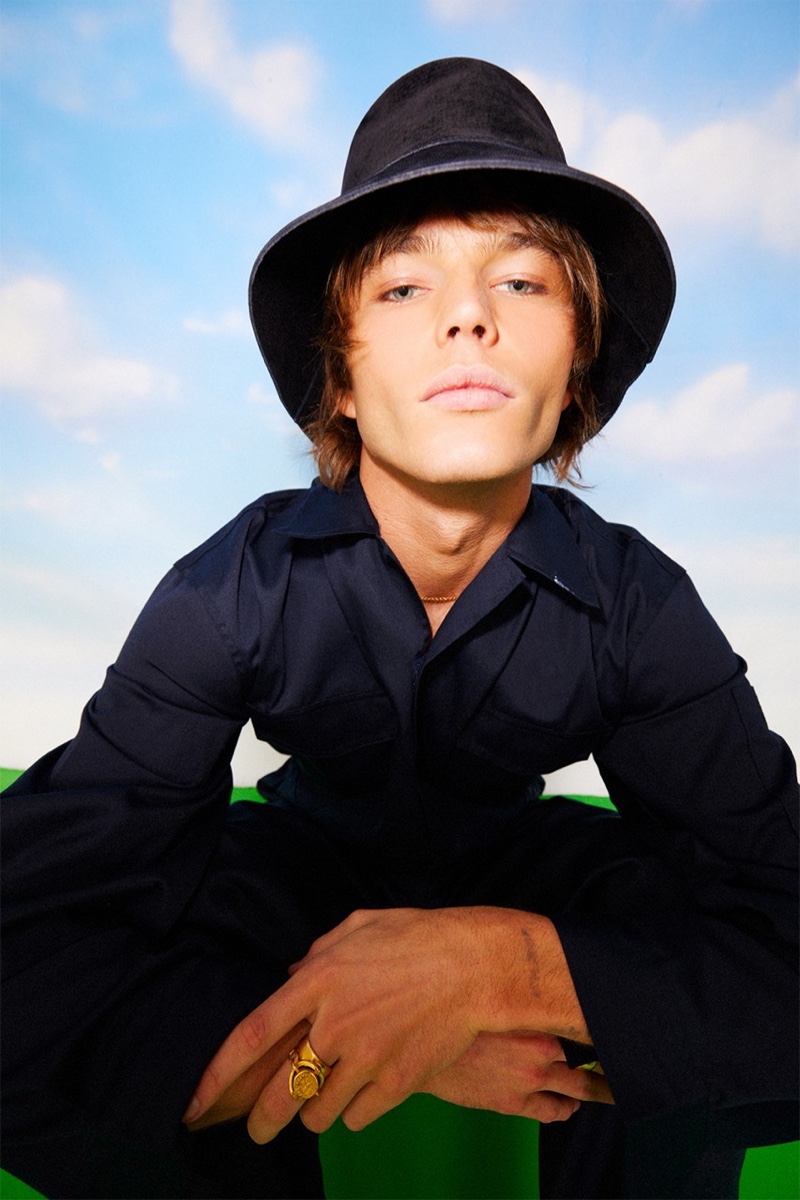 Making a stylish statement, Jordan Barrett dons a black suede bucket hat from his Lack of Color collaboration.