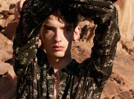 In front and center, Kodi Smit-McPhee sports a black abstract snake print shirt with a silver bracelet and rings for Zara Man's spring-summer 2022 Studio collection campaign.