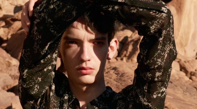 In front and center, Kodi Smit-McPhee sports a black abstract snake print shirt with a silver bracelet and rings for Zara Man's spring-summer 2022 Studio collection campaign.