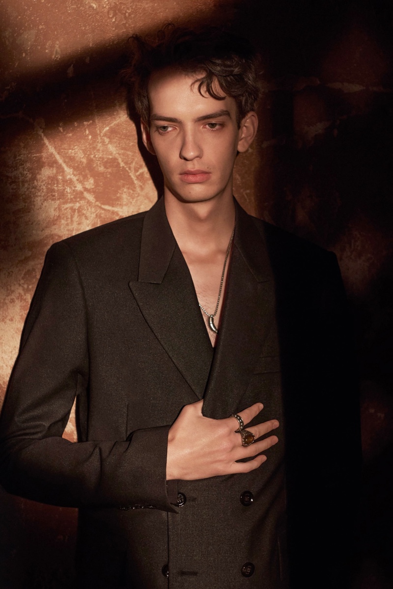 Connecting with Zara, Kodi Smit-McPhee wears a black double-breasted suit with a silver horn necklace for the brand's spring-summer 2022 Studio collection campaign.
