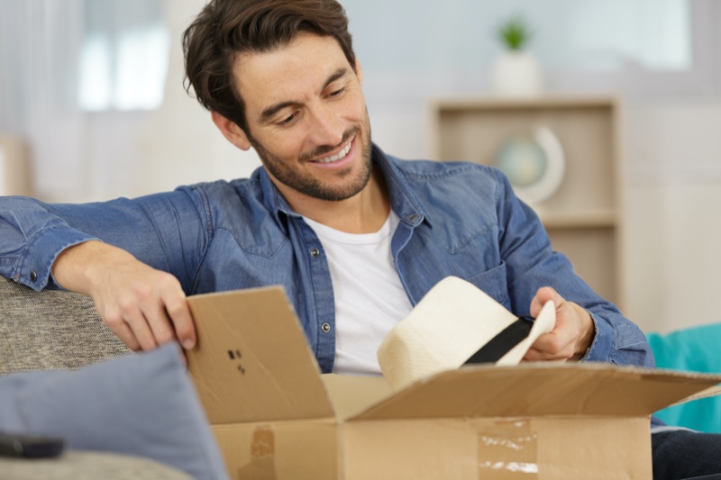 Man Opening Box with Hat