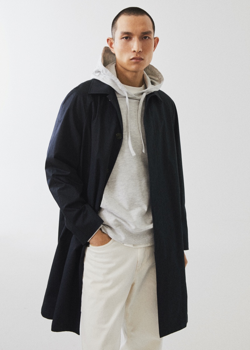 Chinese model Zhang Wenhui dons a Mango Man hoodie with a navy trench and light-colored pants.