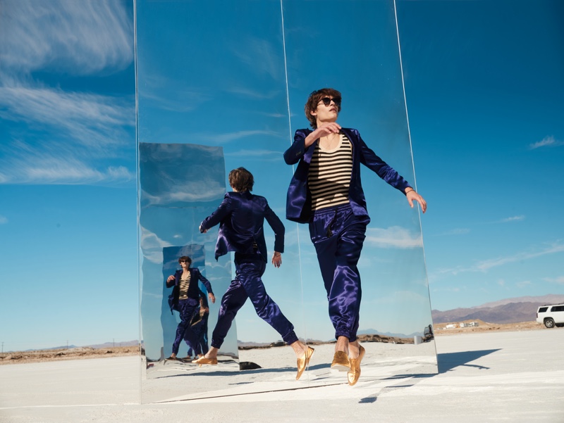 Model Liam Kelly suits up in a luxurious number from Saint Laurent for Neiman Marcus' spring-summer 2022 men's campaign.