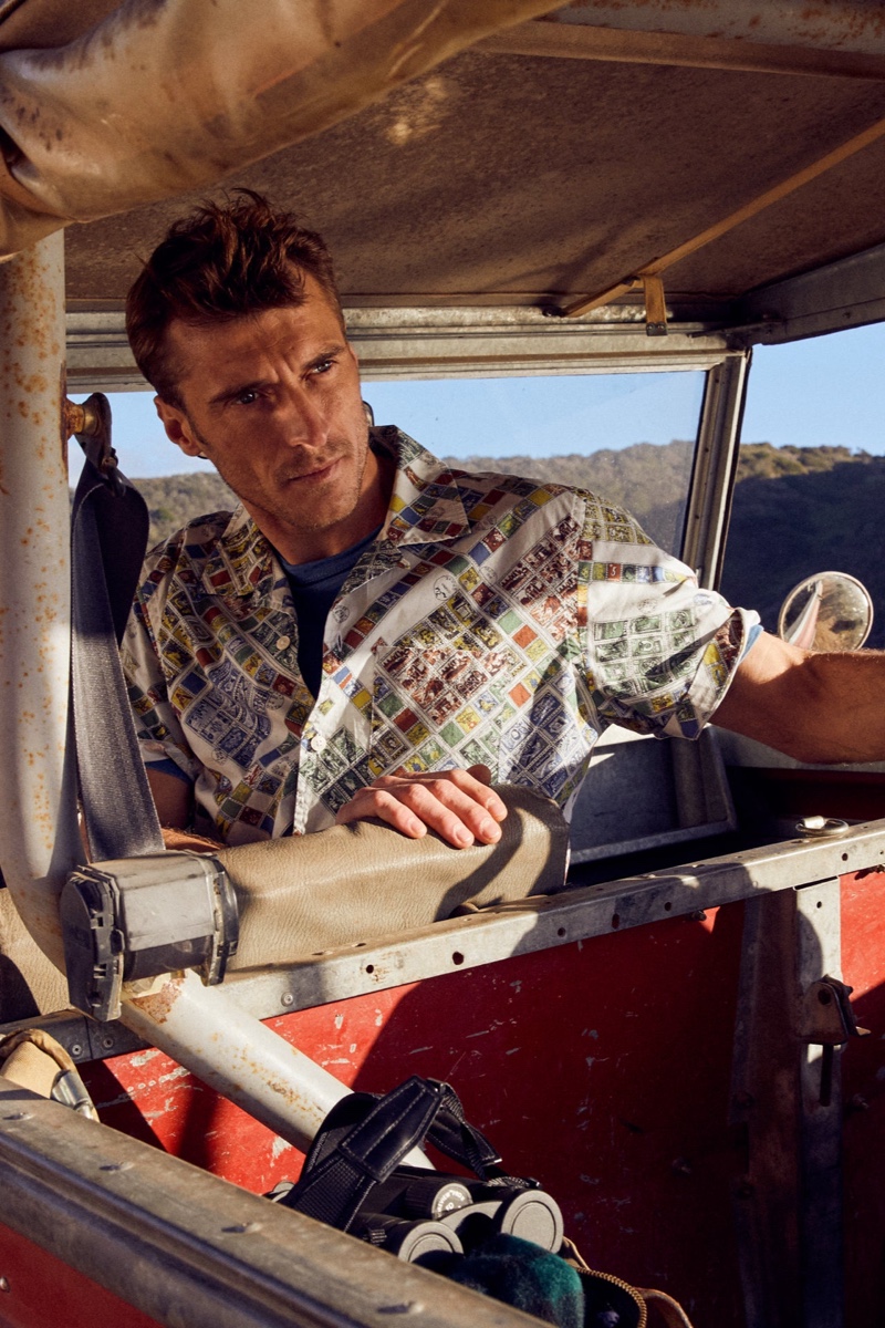 French model Clément Chabernaud goes bold in a stamp print short-sleeve camp collar shirt from Todd Snyder.