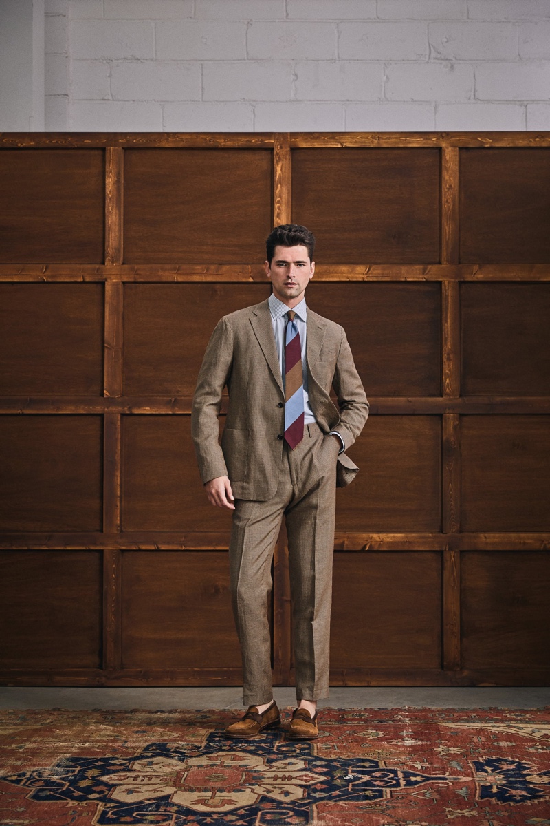 In front and center, Sean O'Pry dons an Italian soft Sutton suit in brown houndstooth by Todd Snyder.