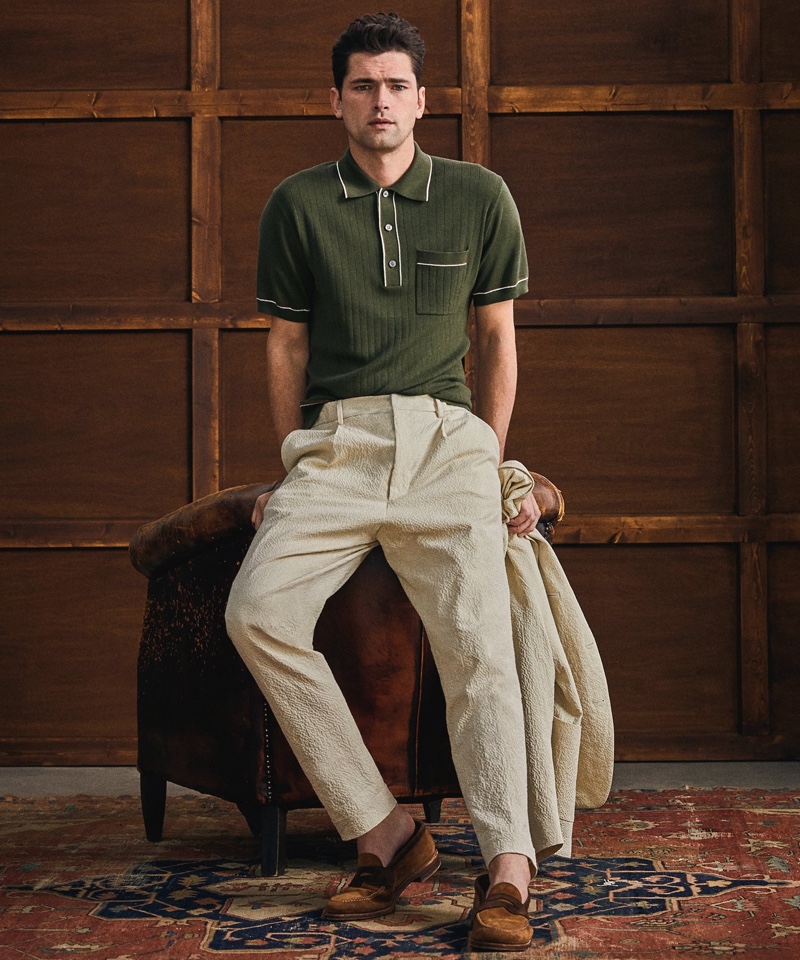 A smart vision, Sean O'Pry dons an Italian cotton silk tipped ribbed polo sweater in olive with Todd Snyder's Italian seersucker Traveler suit in stone.