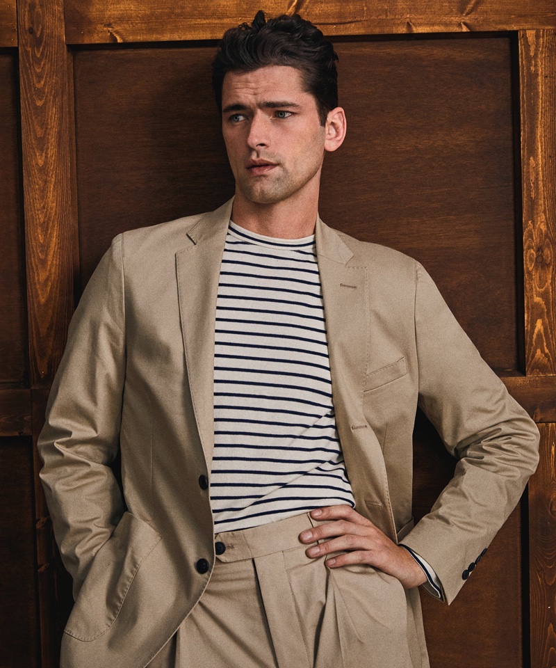 American model Sean O'Pry cleans up in Todd Snyder's Italian cotton twill Madison suit in sand stone. He also wears an Issued by: Japanese nautical striped tee.