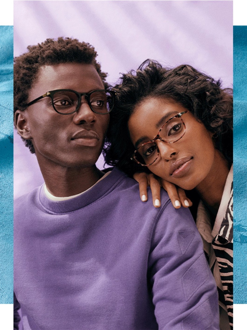 Models George Okeny and Senait Gidey model Warby Parker's latest eyewear styles. George wears the Durand glasses in Jet Black with Polished Gold while Senait dons the Daisy in Violet Quartz Crystal with Polished Silver.