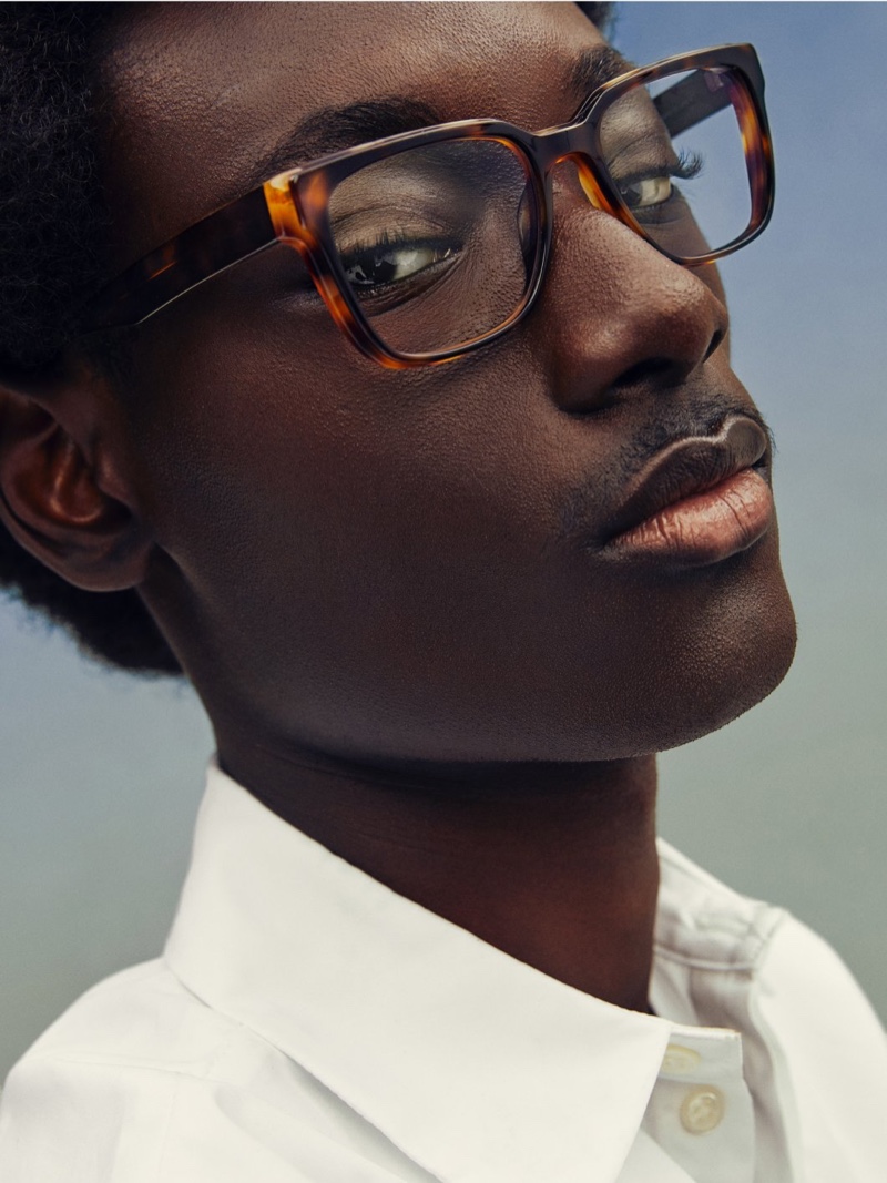 Youssouf Bamba wears Warby Parker's Cumberland glasses in Burnt Umber Tortoise with Marcona Tortoise.