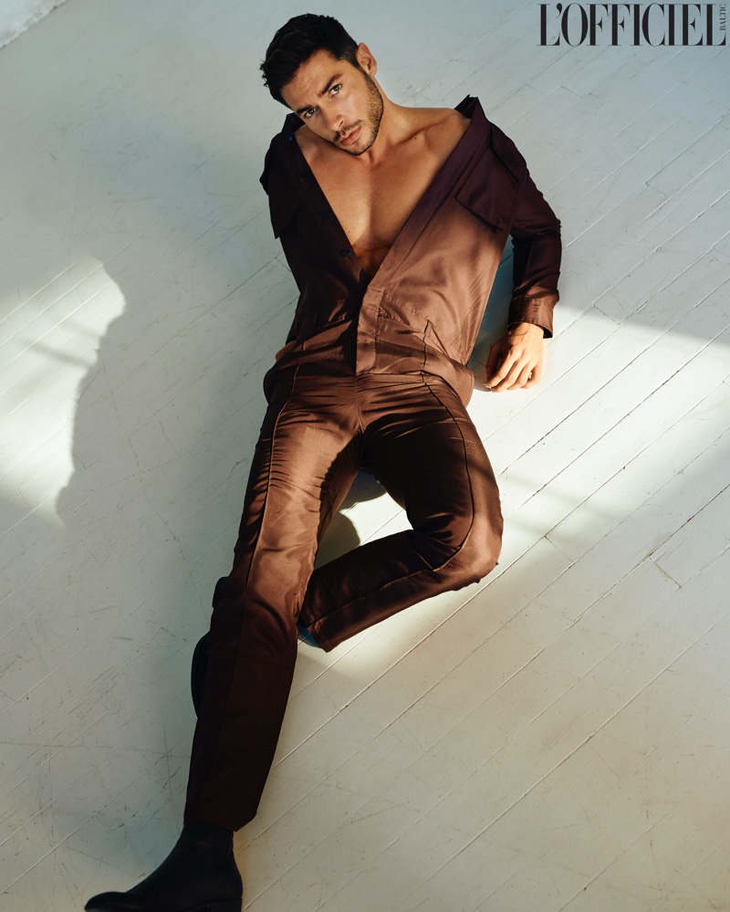 Making a statement in brown, Andrea Denver wears a Valentino jumpsuit with Saint Laurent boots for L'Officiel Baltics.