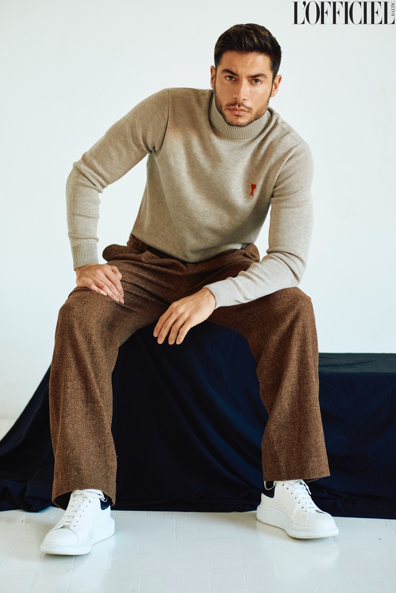 A chic vision, Andrea Denver dons an AMI turtleneck, Vince pants, and Alexander McQueen shoes for L'Officiel Baltics.