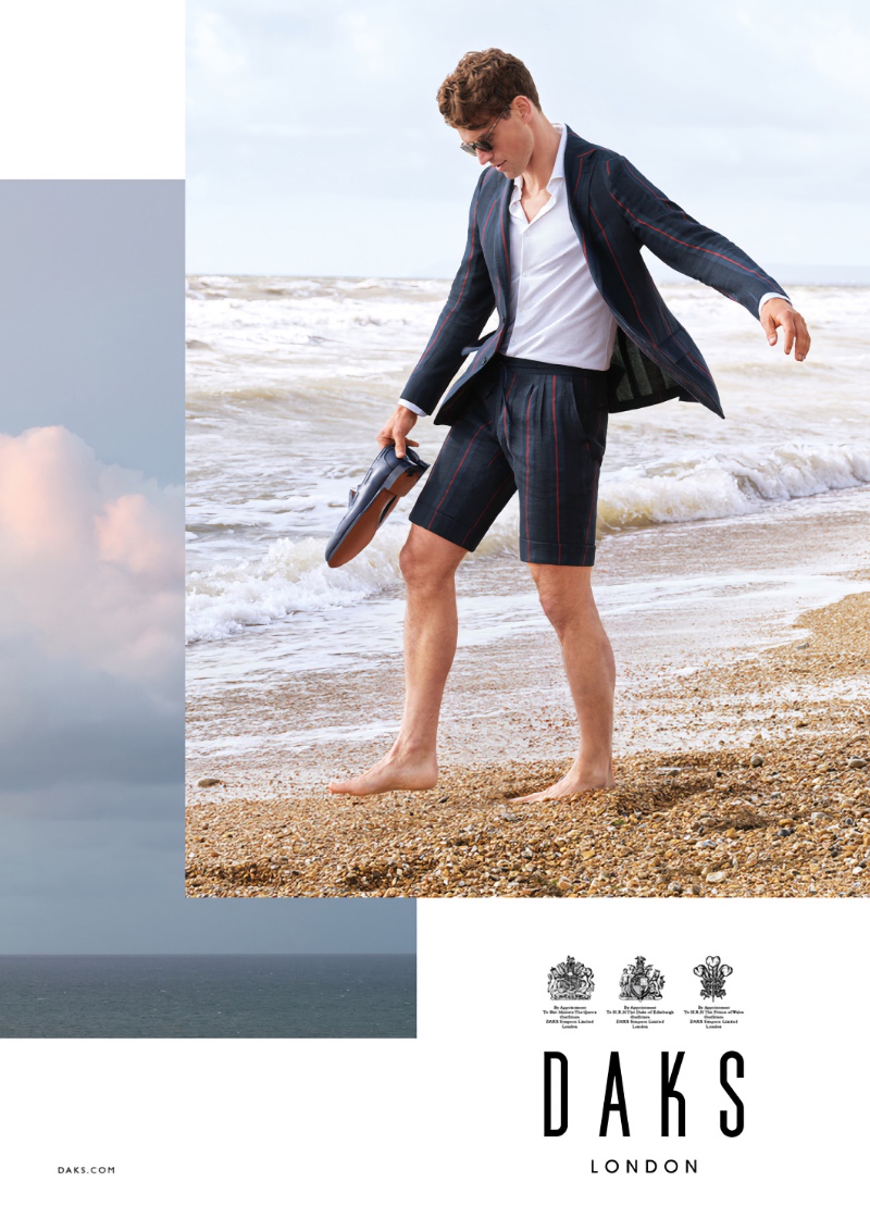 Taking to the beach in a short suit, Guy Robinson fronts Daks London's spring-summer 2022 campaign.