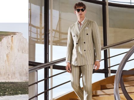 Donning a striped double-breasted linen suit, Guy Robinson stars in Daks London's spring-summer 2022 campaign.