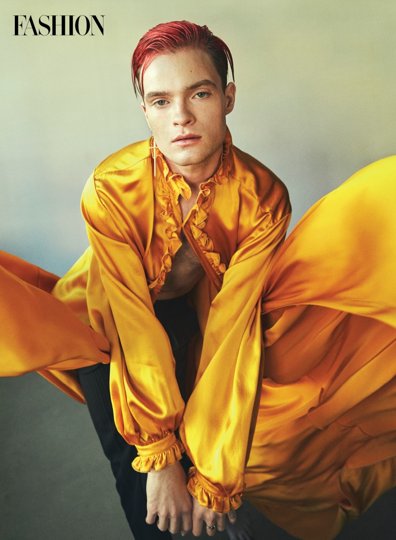 Making a golden statement for Fashion magazine, Jake Wesley Rogers rocks a cloak, pants, and ring by Saint Laurent. Photo Credit: Greg Swales