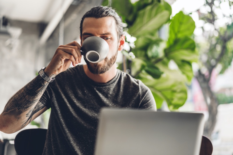 Man on Laptop Drinking Coffee